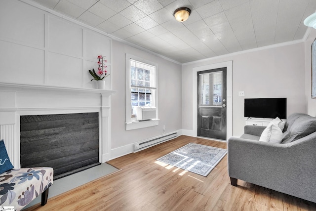 living area featuring a baseboard radiator, a fireplace with flush hearth, wood finished floors, and crown molding