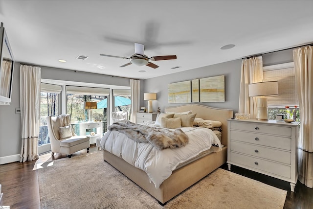 bedroom with dark wood finished floors, access to exterior, and visible vents