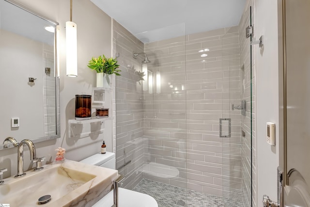 full bathroom with a shower stall, toilet, and vanity