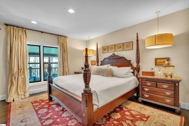 bedroom with recessed lighting, wood finished floors, and baseboards