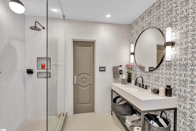 full bathroom featuring tile patterned floors, tile walls, vanity, and walk in shower