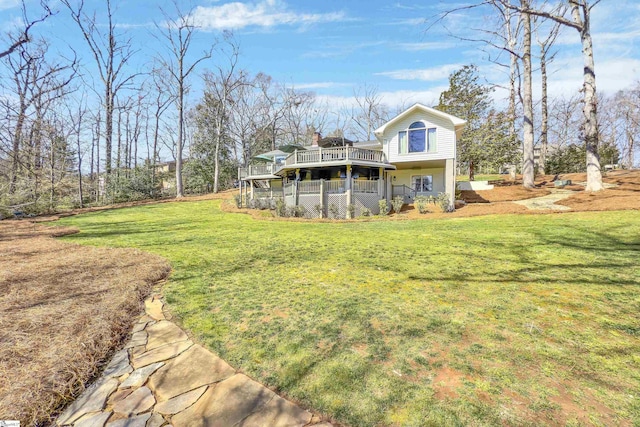 rear view of property featuring a wooden deck and a yard