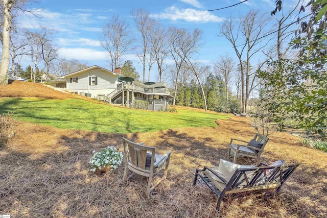 view of yard with stairway and a deck