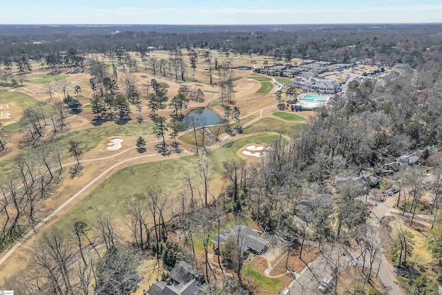 drone / aerial view with golf course view and a water view