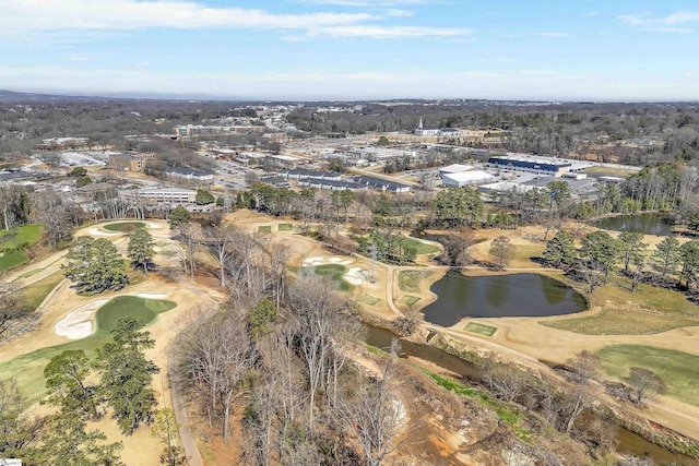 drone / aerial view with golf course view and a water view