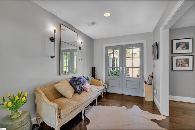 foyer with visible vents, a healthy amount of sunlight, wood finished floors, and french doors