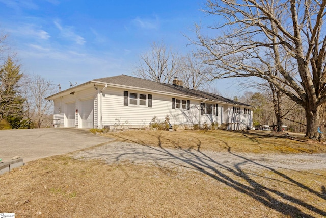 single story home featuring an attached garage, concrete driveway, and a chimney