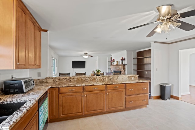 kitchen with brown cabinetry and light stone countertops