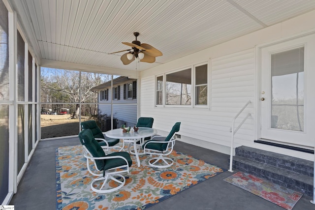 sunroom featuring ceiling fan