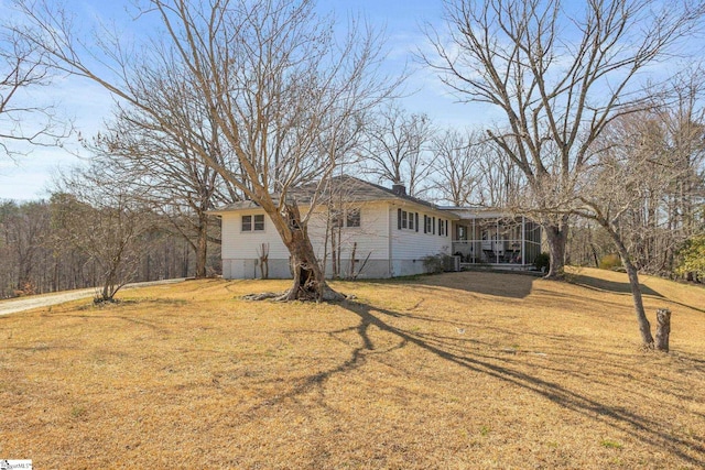 view of front of property featuring crawl space, a chimney, and a front lawn