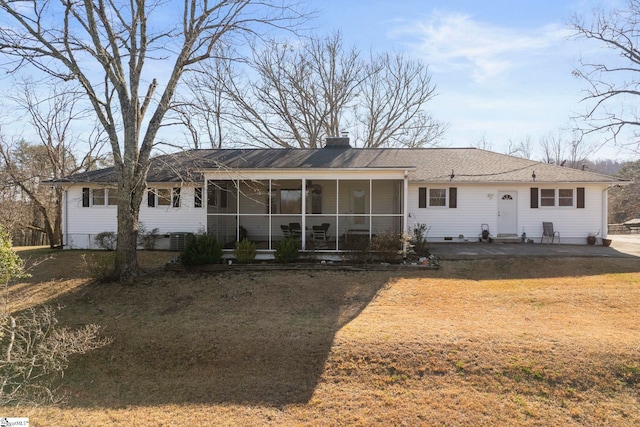 back of house with crawl space, a chimney, and a sunroom