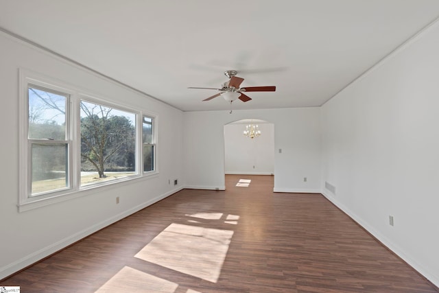 spare room with visible vents, ceiling fan with notable chandelier, baseboards, and dark wood-style flooring