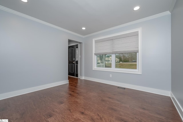 spare room featuring visible vents, baseboards, and ornamental molding