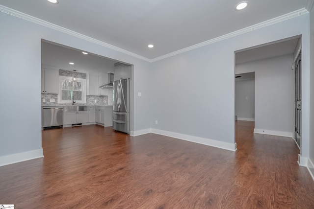 unfurnished living room with crown molding, dark wood-type flooring, and baseboards