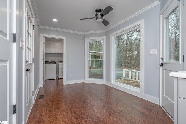 unfurnished sunroom with visible vents, a ceiling fan, and washing machine and clothes dryer