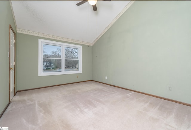 spare room with baseboards, carpet floors, high vaulted ceiling, and a ceiling fan