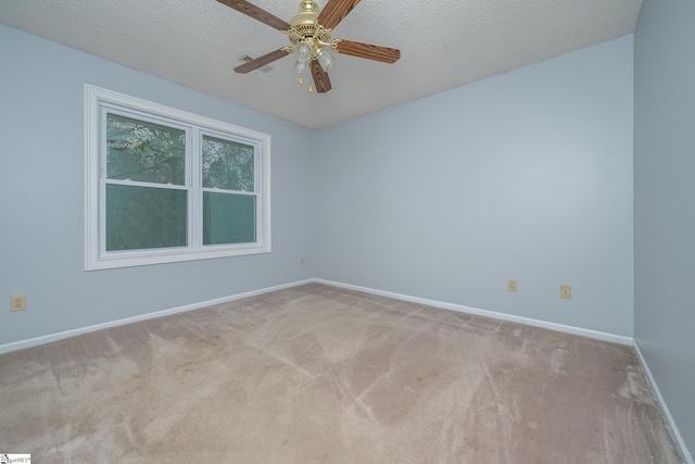 spare room featuring baseboards, a textured ceiling, ceiling fan, and carpet flooring