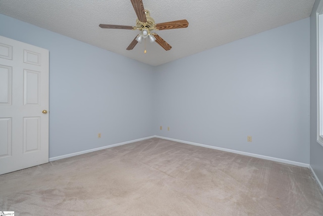 unfurnished room with light carpet, baseboards, a textured ceiling, and a ceiling fan