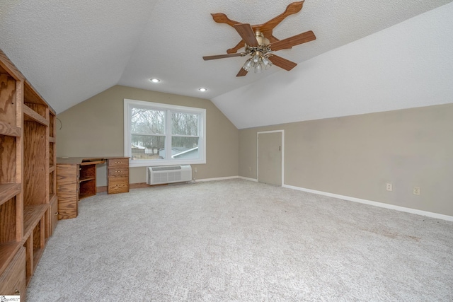 additional living space featuring a textured ceiling, lofted ceiling, and baseboards