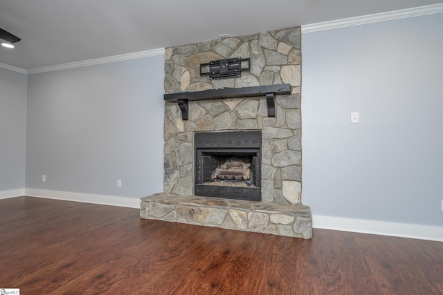 unfurnished living room with a stone fireplace, crown molding, wood finished floors, and baseboards