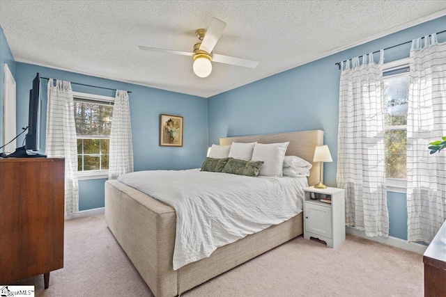 bedroom with light colored carpet, a textured ceiling, and ceiling fan