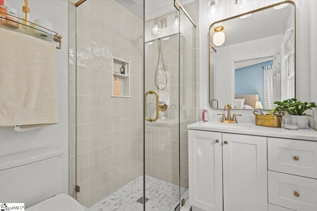 full bath featuring a shower stall, vanity, and ensuite bathroom