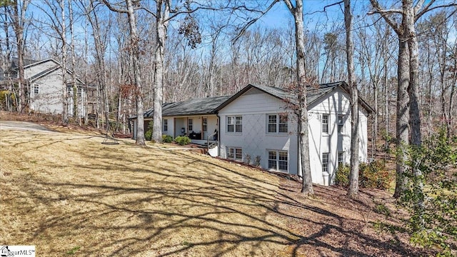 rear view of property featuring a yard