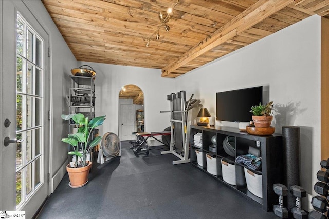 exercise room with arched walkways and wooden ceiling