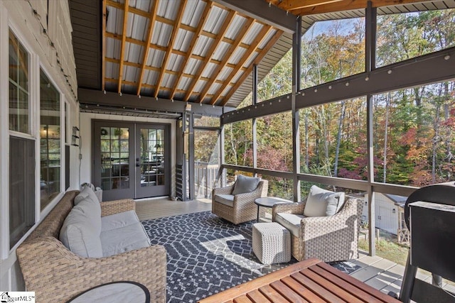 sunroom featuring french doors and lofted ceiling with beams