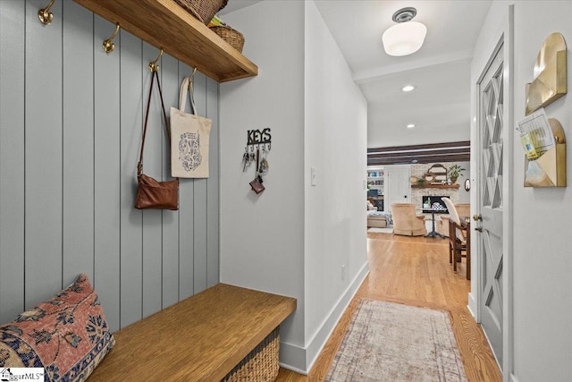 mudroom featuring recessed lighting, a fireplace, light wood-type flooring, and baseboards