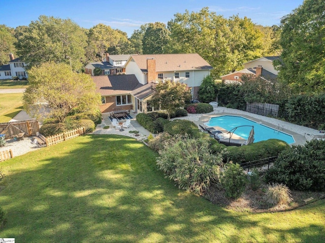 view of pool featuring a patio, a yard, a fenced backyard, and a fenced in pool