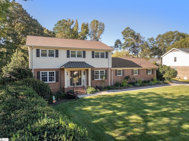 view of front of property with brick siding and a front lawn