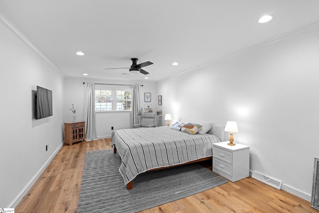 bedroom featuring light wood finished floors, visible vents, crown molding, baseboards, and recessed lighting