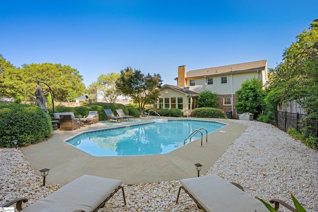 view of pool featuring a fenced in pool, a patio, and fence