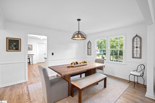 dining space with baseboards, light wood-type flooring, and breakfast area