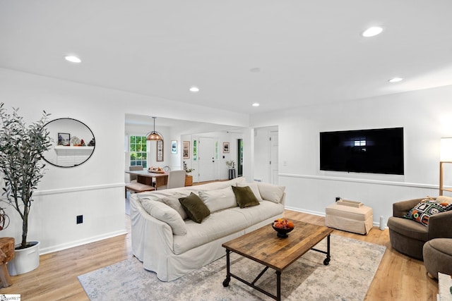 living room featuring recessed lighting, light wood-type flooring, and baseboards