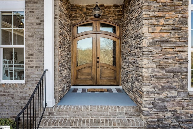 entrance to property with french doors and stone siding