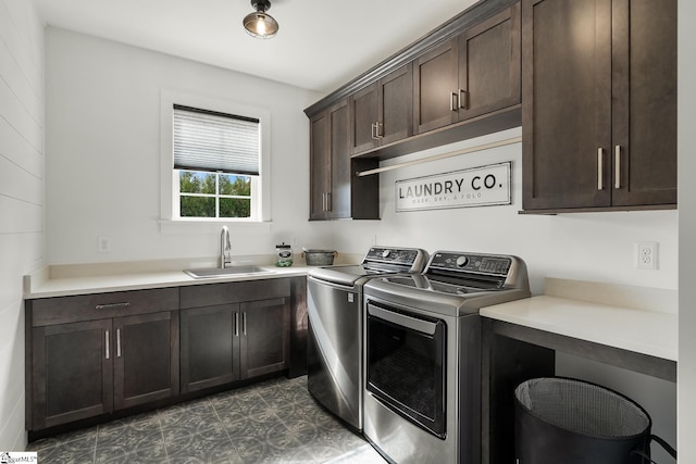 washroom with a sink, cabinet space, and independent washer and dryer