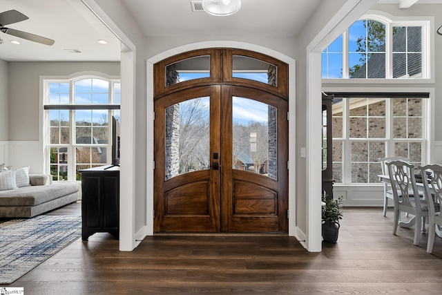 foyer featuring dark wood-style floors, visible vents, recessed lighting, and wainscoting