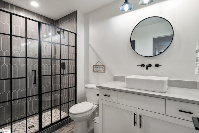 full bath with vanity, toilet, and tiled shower