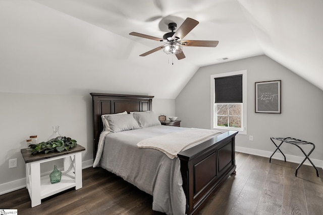 bedroom featuring baseboards, visible vents, dark wood finished floors, lofted ceiling, and ceiling fan