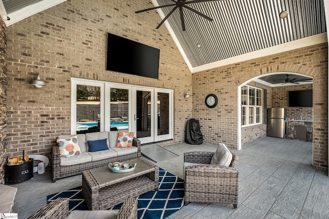 view of patio featuring ceiling fan, french doors, an outdoor living space, and exterior kitchen