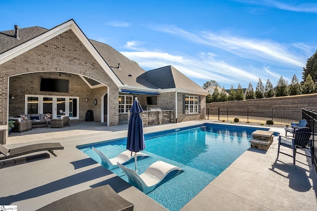 view of swimming pool with a fenced in pool, outdoor lounge area, a fenced backyard, a patio area, and area for grilling