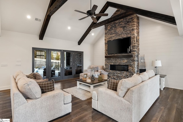 living room with beam ceiling, high vaulted ceiling, dark wood-style floors, french doors, and a stone fireplace