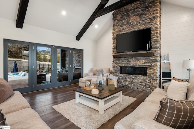 living room with beamed ceiling, a fireplace, and wood finished floors