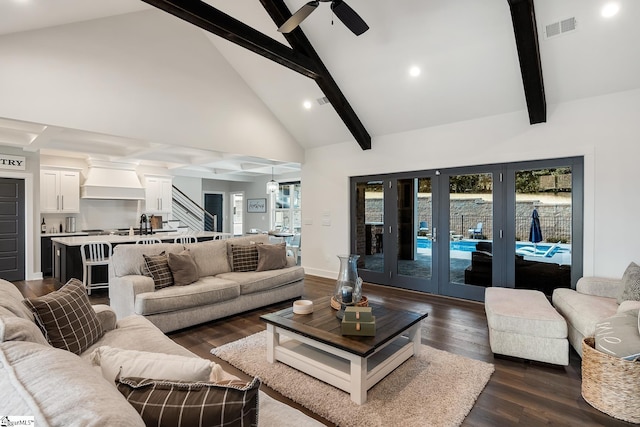 living area with beam ceiling, visible vents, a healthy amount of sunlight, and dark wood-type flooring