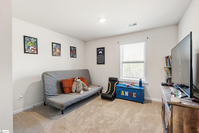 living area featuring carpet flooring, visible vents, and baseboards