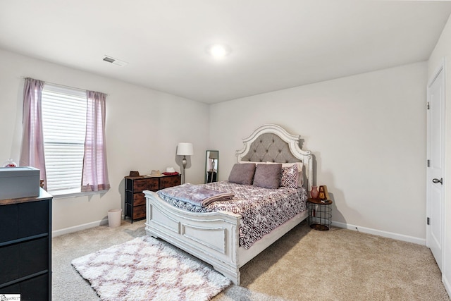 bedroom featuring visible vents, carpet flooring, and baseboards