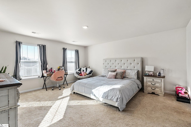 bedroom with visible vents, baseboards, and light colored carpet