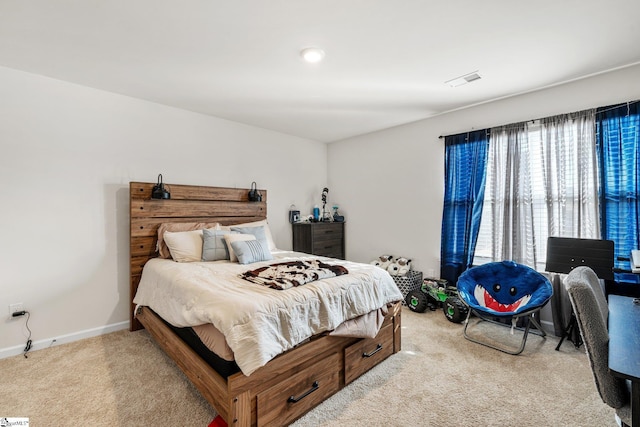 carpeted bedroom with visible vents and baseboards